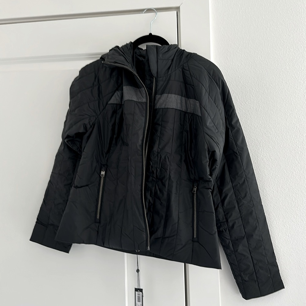 Brand new Aether jacket. inside zipper pockets and hood. Great travel coat!